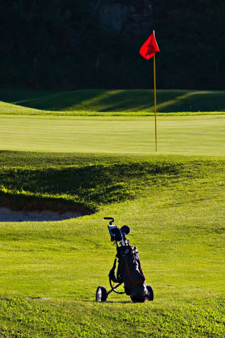 golf course flag and clubs photo